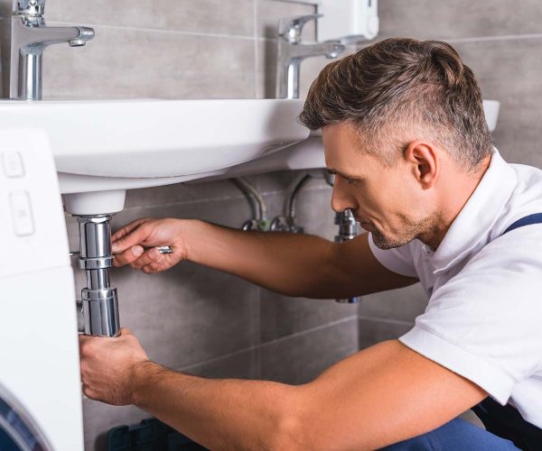 adult-plumber-fixing-sink-at-bathroom-resize.jpg