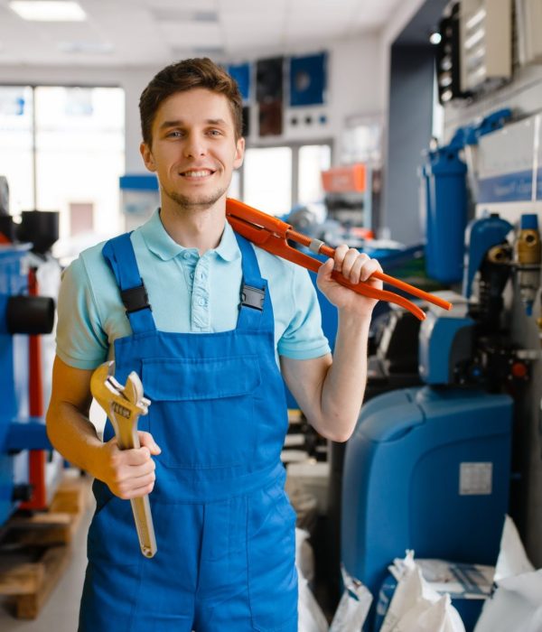 plumber-shows-pipe-wrenches-in-plumbering-store